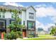 Townhome exterior showcasing modern design, brick accents, and vibrant orange front door framed by green landscaping at 648 W End Dr, Charlotte, NC 28208