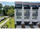 Aerial view of modern townhomes with rooftop decks, private garages, and well maintained lawns at 648 W End Dr, Charlotte, NC 28208