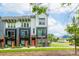 Modern townhome with a brick facade, black framed windows, and a vibrant orange front door at 648 W End Dr, Charlotte, NC 28208