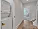 Hallway laundry closet with stackable appliances and natural light from the nearby bedroom at 648 W End Dr, Charlotte, NC 28208