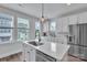 Bright kitchen with stainless steel appliances, an island with a sink, and natural light from the windows at 648 W End Dr, Charlotte, NC 28208