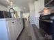 Modern kitchen featuring stainless steel appliances, a kitchen island, white cabinets, and an open floor plan at 648 W End Dr, Charlotte, NC 28208