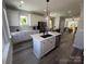Open-concept kitchen featuring a center island, white cabinets, stainless steel appliances, and modern finishes at 648 W End Dr, Charlotte, NC 28208