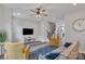 Bright living room featuring hard floors, a ceiling fan, stairs, and comfortable seating in an open-concept design at 648 W End Dr, Charlotte, NC 28208