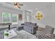 Bright living room with modern decor, a gray sectional sofa, and large windows with natural light at 648 W End Dr, Charlotte, NC 28208