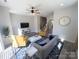 View of the living room featuring yellow accent chairs, ceiling fan and natural light at 648 W End Dr, Charlotte, NC 28208