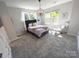 Bright primary bedroom with three windows and a modern chandelier at 648 W End Dr, Charlotte, NC 28208