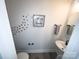 Compact half bathroom with a modern sink and decorative wall art at 648 W End Dr, Charlotte, NC 28208