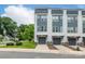 Rear exterior of a modern two-story townhome highlighting a two car garage and manicured landscaping at 648 W End Dr, Charlotte, NC 28208
