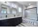 Modern bathroom with a double vanity, sleek black fixtures, and a glass-enclosed shower featuring marble-style tiling at 7005 W Duncan Rd, Indian Trail, NC 28079