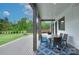 Inviting covered patio with outdoor dining set, offering a comfortable space for relaxation and outdoor meals at 7005 W Duncan Rd, Indian Trail, NC 28079