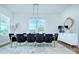 Sun-filled dining room is adorned with velvet chairs, modern lighting and a decorative mirror at 7005 W Duncan Rd, Indian Trail, NC 28079