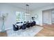 Bright dining area featuring hardwood flooring, designer lighting, contemporary furniture, and multiple windows at 7005 W Duncan Rd, Indian Trail, NC 28079