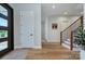 Bright foyer with hardwood floors, staircase, a modern front door, and neutral decor at 7005 W Duncan Rd, Indian Trail, NC 28079