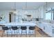 Stylish kitchen featuring white cabinets, a marble island, and modern pendant lighting at 7005 W Duncan Rd, Indian Trail, NC 28079