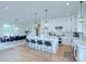 Bright open kitchen features a large island with bar seating, stainless appliances, and hardwood floors at 7005 W Duncan Rd, Indian Trail, NC 28079