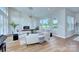 Bright living room with stone fireplace, hardwood floors, large windows and vaulted ceilings at 7005 W Duncan Rd, Indian Trail, NC 28079
