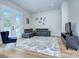 Comfortable living room with a sectional sofa, hardwood floors, and direct access to the yard at 7005 W Duncan Rd, Indian Trail, NC 28079