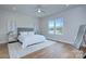 Bright main bedroom with tufted headboard, hardwood floors, and natural light at 7005 W Duncan Rd, Indian Trail, NC 28079