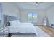 Bright main bedroom with tufted headboard, hardwood floors, and natural light at 7005 W Duncan Rd, Indian Trail, NC 28079