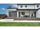 Expansive back of the home with a covered patio, multi-level deck, lush lawn, and elegant landscaping at 7005 W Duncan Rd, Indian Trail, NC 28079