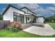 Stunning rear view of the home showcasing a covered patio, a deck, and a manicured lawn surrounded by greenery at 7005 W Duncan Rd, Indian Trail, NC 28079
