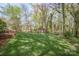 Green backyard with trees and shed at 726 Grandview Ne Dr, Concord, NC 28025