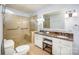 Bathroom features a double sink vanity with marble countertop and a glass-enclosed shower with seat at 726 Grandview Ne Dr, Concord, NC 28025