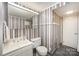Bathroom boasts a white vanity, mirror, and vertical striped wallpaper at 726 Grandview Ne Dr, Concord, NC 28025
