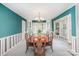 Bright dining room with bay window, custom cabinetry, and hardwood table illuminated by elegant chandelier at 726 Grandview Ne Dr, Concord, NC 28025
