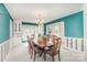 Bright dining room with bay window, custom cabinetry, and hardwood table illuminated by elegant chandelier at 726 Grandview Ne Dr, Concord, NC 28025