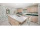 Spacious kitchen with an island featuring a cooktop, ample cabinetry, and a double basin sink at 726 Grandview Ne Dr, Concord, NC 28025