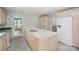 Spacious kitchen with an island featuring a cooktop, ample cabinetry, and access to the dining room at 726 Grandview Ne Dr, Concord, NC 28025