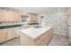 Spacious kitchen with an island featuring a cooktop, ample cabinetry, and a double basin sink at 726 Grandview Ne Dr, Concord, NC 28025