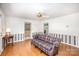 Light-filled living area features hardwood floors, neutral walls, ceiling fan, and backyard views at 726 Grandview Ne Dr, Concord, NC 28025