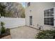 A cozy patio featuring a white fence, door to the house, and some plants at 7445 Abigail Glen Dr, Charlotte, NC 28212