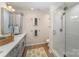 A bathroom has a glass shower and a vanity with cabinets at 7445 Abigail Glen Dr, Charlotte, NC 28212