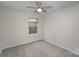 Neutral bedroom with a ceiling fan, a window offering natural light and plush carpeting for comfort at 7445 Abigail Glen Dr, Charlotte, NC 28212