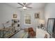 Comfortable bedroom with a ceiling fan, a window, and unique decor providing a personalized touch at 7445 Abigail Glen Dr, Charlotte, NC 28212
