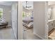 Hallway view into the main bedroom that features a ceiling fan and a window at 7445 Abigail Glen Dr, Charlotte, NC 28212