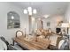 A dining room table sits in the foreground, with a living room featuring a fireplace in the background at 7445 Abigail Glen Dr, Charlotte, NC 28212