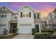 Charming exterior elevation showcasing a two-story townhouse with garage and well-maintained landscaping at 7445 Abigail Glen Dr, Charlotte, NC 28212
