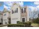 Inviting townhome exterior featuring a garage, brick accents, and tidy landscaping at 7445 Abigail Glen Dr, Charlotte, NC 28212