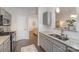 A view of the kitchen with stainless steel appliances and gray cabinets that opens to the living room at 7445 Abigail Glen Dr, Charlotte, NC 28212