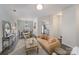 Open-concept living area with modern furniture, dining space, and hardwood floors at 7445 Abigail Glen Dr, Charlotte, NC 28212