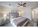 The spacious main bedroom has a ceiling fan, carpeted floors, and a bright window at 7445 Abigail Glen Dr, Charlotte, NC 28212