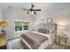 The spacious main bedroom has a ceiling fan, carpeted floors, and a bright window at 7445 Abigail Glen Dr, Charlotte, NC 28212