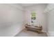 Spacious walk-in closet with built-in shelving and a cozy bench placed near a window at 7445 Abigail Glen Dr, Charlotte, NC 28212