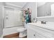 Updated bathroom featuring a shower with glass doors, toilet and white vanity at 8301 Washington Blvd, Charlotte, NC 28262