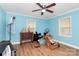 Bright bedroom with hardwood floors, ceiling fan, and two windows at 8301 Washington Blvd, Charlotte, NC 28262